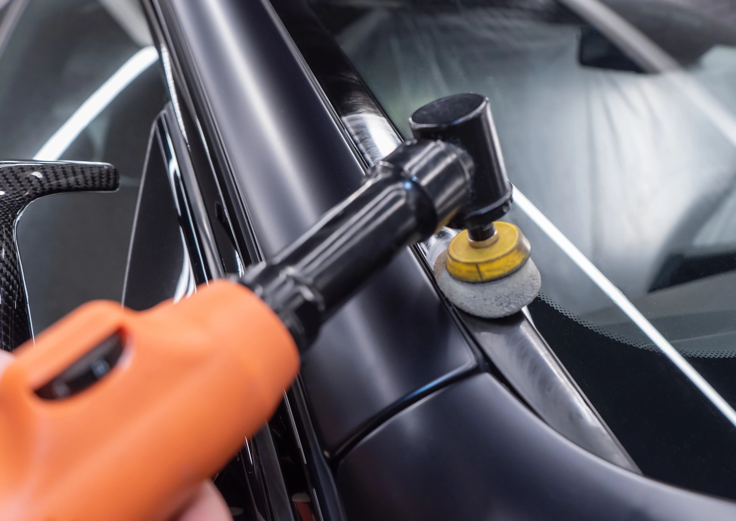 Close-up of a car being polished during detailing