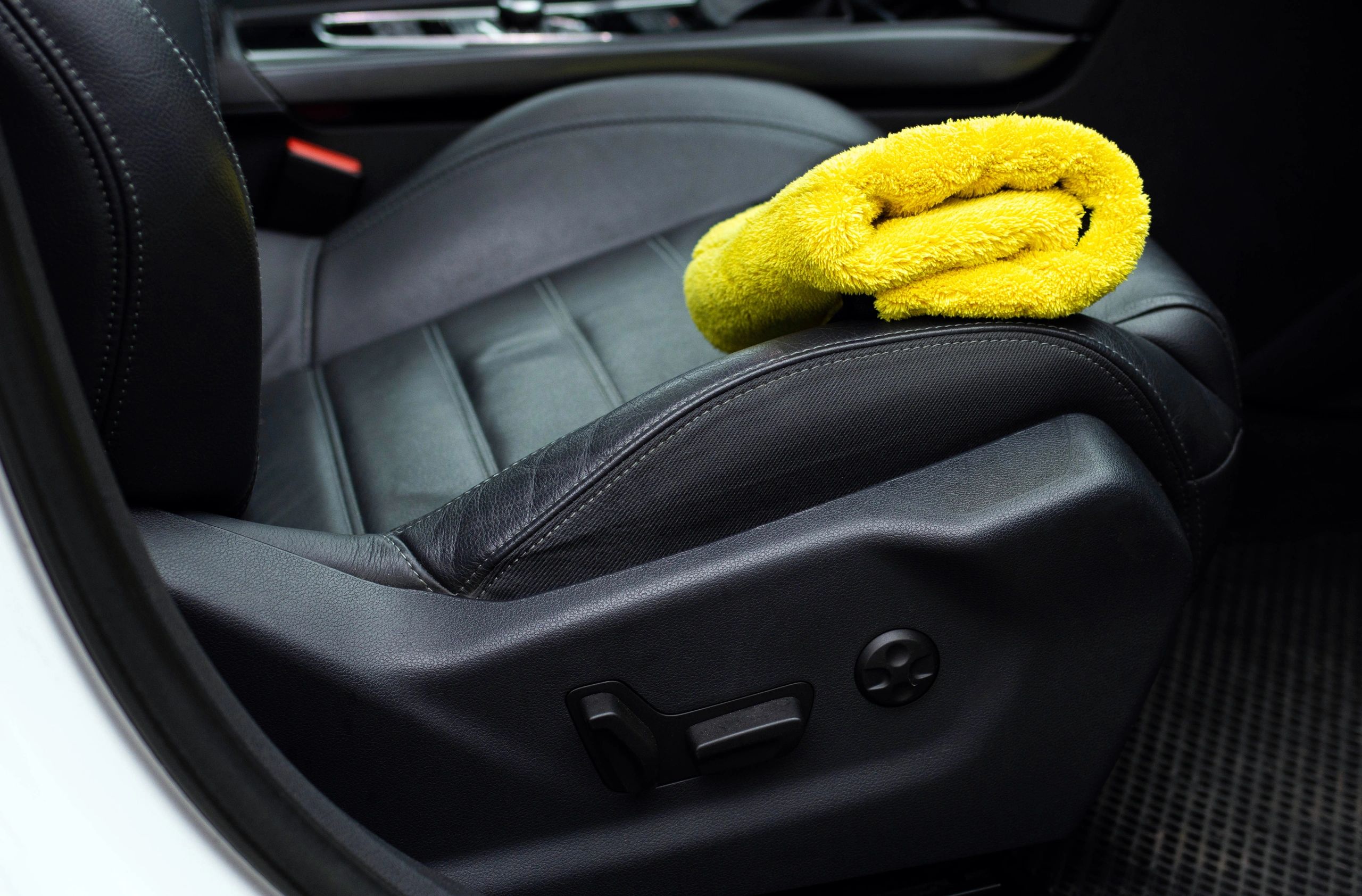 Microfiber cloth on clean leather car seat